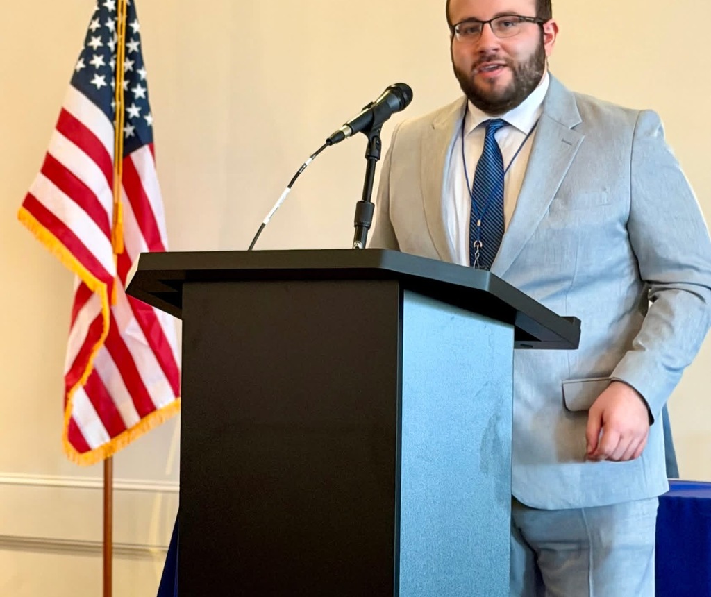Kyle Gornick standing at a podium